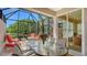 Covered patio with comfortable seating, a table setting and backyard views at 7004 Old Tabby Cir, Lakewood Ranch, FL 34202