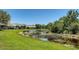 Scenic pond view with lush green grass and trees, showcasing the community's natural beauty at 7004 Old Tabby Cir, Lakewood Ranch, FL 34202