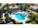 A relaxing community pool and spa surrounded by lush landscaping and lounge chairs at 7004 Old Tabby Cir, Lakewood Ranch, FL 34202