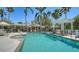 Resort-style community pool with an attached spa, lounge chairs, umbrellas, and a pool house at 7004 Old Tabby Cir, Lakewood Ranch, FL 34202
