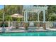 Poolside spa with an umbrella, a table and chairs, and a safety ring at 7004 Old Tabby Cir, Lakewood Ranch, FL 34202