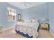 Light blue bedroom featuring a full bed with a white comforter and blue trim and small window at 730 Foggy Morn Ln, Bradenton, FL 34212