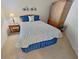 Comfortable bedroom with side table, lamp, wall art, and wardrobe with storage at 730 Foggy Morn Ln, Bradenton, FL 34212