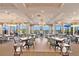 The dining area boasts high ceilings, elegant lighting, and large windows with views of the surrounding landscape at 730 Foggy Morn Ln, Bradenton, FL 34212