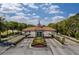Well-manicured gated entrance featuring beautiful landscaping and a guard house at 730 Foggy Morn Ln, Bradenton, FL 34212