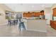 Bright and airy kitchen with wood cabinets, barstool seating and adjoining breakfast nook with exterior views at 730 Foggy Morn Ln, Bradenton, FL 34212