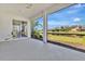 Spacious screened lanai with ceiling fan and views of the pond and neighboring homes at 730 Foggy Morn Ln, Bradenton, FL 34212