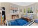 Cozy living room area featuring tile floors, a large window with shutters, and a comfortable blue sofa at 730 Foggy Morn Ln, Bradenton, FL 34212
