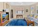 Inviting living room featuring tile floors, a large window with shutters and a comfortable blue sofa at 730 Foggy Morn Ln, Bradenton, FL 34212