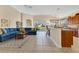 Bright, open-concept living space featuring tile floors connecting the living room and kitchen area at 730 Foggy Morn Ln, Bradenton, FL 34212