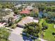 Beautiful aerial view of a home with a tiled roof and a screened-in pool overlooking a tranquil lake at 742 Shadow Bay Way, Osprey, FL 34229