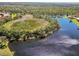 An aerial view captures the scenic beauty of a marshland area with abundant vegetation and serene waters at 742 Shadow Bay Way, Osprey, FL 34229