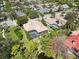 A cozy home with a screened pool and tile roof is set amongst lush greenery in a charming neighborhood at 742 Shadow Bay Way, Osprey, FL 34229