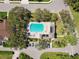 An aerial view showcases a community pool and surrounding recreational area with lush greenery and comfortable seating at 742 Shadow Bay Way, Osprey, FL 34229