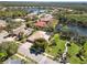 A charming home with a screened-in pool and a tile roof is surrounded by lush landscaping and a beautiful lake at 742 Shadow Bay Way, Osprey, FL 34229