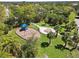 Aerial view of a playground featuring slides, swings and walkways shaded by trees in a lush green space at 742 Shadow Bay Way, Osprey, FL 34229
