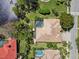 Aerial view of a home with a screened pool and an expansive tile roof in a picturesque neighborhood at 742 Shadow Bay Way, Osprey, FL 34229