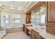 Elegant bathroom featuring double vanities, a soaking tub, walk-in shower and abundant natural light at 742 Shadow Bay Way, Osprey, FL 34229