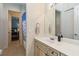 Bright bathroom featuring a white vanity with tan cabinets, a large mirror, and a shower/tub combo at 742 Shadow Bay Way, Osprey, FL 34229