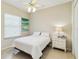 Bright bedroom with a ceiling fan, light tile flooring, and a large window allowing for natural light at 742 Shadow Bay Way, Osprey, FL 34229