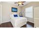 Bedroom with hardwood floors, white furniture, and a cozy ambiance enhanced by natural light at 742 Shadow Bay Way, Osprey, FL 34229