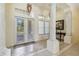 Bright foyer featuring elegant tile flooring, decorative columns, and an abundance of natural light at 742 Shadow Bay Way, Osprey, FL 34229