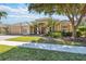 Attractive single-story home featuring manicured landscaping, a paver driveway, and a welcoming double-door entryway at 742 Shadow Bay Way, Osprey, FL 34229
