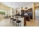 Bright, open kitchen featuring dark wood cabinets, and black countertops with seating at 742 Shadow Bay Way, Osprey, FL 34229