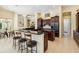 Large open kitchen features dark wood cabinets, stone countertops and island seating at 742 Shadow Bay Way, Osprey, FL 34229