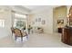 Inviting living room with tile flooring, comfortable seating, and sliding glass doors leading to the outdoor space at 742 Shadow Bay Way, Osprey, FL 34229
