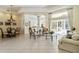Spacious living room with tile flooring, elegant furnishings, and large windows offering a bright and airy atmosphere at 742 Shadow Bay Way, Osprey, FL 34229