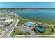 Overhead shot of a community pool, clubhouse, playground and tennis courts near the beautiful lake at 7712 Saloon Ln, Sarasota, FL 34240
