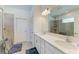 Bright bathroom featuring double sinks, quartz countertops and tile shower with a window at 7712 Saloon Ln, Sarasota, FL 34240