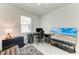 Modern bedroom featuring a ceiling fan, a window, and a TV on a stand at 7712 Saloon Ln, Sarasota, FL 34240