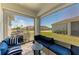 Comfortable screened porch featuring outdoor seating and views of the backyard at 7712 Saloon Ln, Sarasota, FL 34240