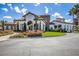 Clubhouse with stone and stucco exterior, tile roof, and lush landscaping at 7977 Bowspirit Way, Lakewood Ranch, FL 34202