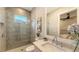 Bathroom featuring tiled glass shower, artwork, and chrome faucet at 8348 Catamaran Cir, Lakewood Ranch, FL 34202