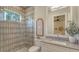 Well-lit bathroom showcasing tiled shower and vanity with vessel sink at 8348 Catamaran Cir, Lakewood Ranch, FL 34202