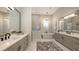 Beautiful primary bathroom with dual sinks, standalone tub, glass shower, and chandelier at 8348 Catamaran Cir, Lakewood Ranch, FL 34202