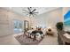 Bedroom offering backyard pool access, modern ceiling fan, and a large window at 8348 Catamaran Cir, Lakewood Ranch, FL 34202