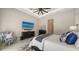 Stylish bedroom featuring a ceiling fan, TV, sitting chair, and decorative pillows at 8348 Catamaran Cir, Lakewood Ranch, FL 34202