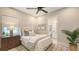 Inviting bedroom with large window, ceiling fan, and an ensuite bathroom at 8348 Catamaran Cir, Lakewood Ranch, FL 34202