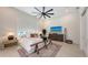 Bedroom with a ceiling fan, large window, TV, and rustic wooden bench at 8348 Catamaran Cir, Lakewood Ranch, FL 34202