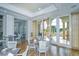 Elegant dining room with modern furnishings, large windows, and views of the surrounding landscape at 8348 Catamaran Cir, Lakewood Ranch, FL 34202