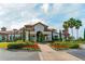 Beautiful clubhouse with a grand entrance, lush landscaping, and a welcoming pathway at 8348 Catamaran Cir, Lakewood Ranch, FL 34202
