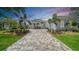 Stately stucco home with a paver drive, manicured landscaping, and a three-car garage at 8348 Catamaran Cir, Lakewood Ranch, FL 34202