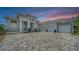 A stunning stucco home featuring a paver drive and a convenient three-car garage at 8348 Catamaran Cir, Lakewood Ranch, FL 34202