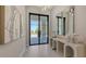 Elegant foyer featuring modern art, a sleek console table, and a view of the paved driveway at 8348 Catamaran Cir, Lakewood Ranch, FL 34202