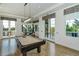 Game room with a pool table, comfortable seating, and abundant natural light at 8348 Catamaran Cir, Lakewood Ranch, FL 34202