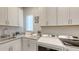 Well-organized laundry room with washer, dryer, sink, and plenty of cabinet storage space at 8348 Catamaran Cir, Lakewood Ranch, FL 34202